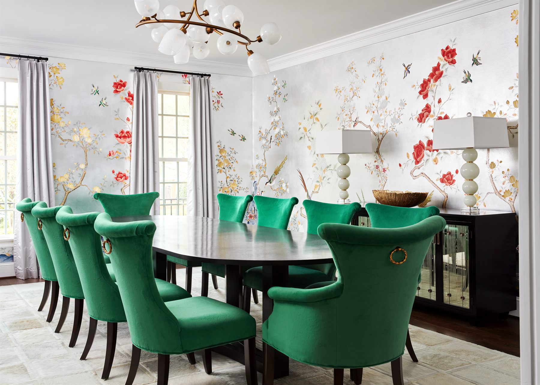 Dining room with chinoiserie wallpaper and emerald velvet chairs